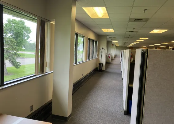 A dim outdated office space before a retrofit. 