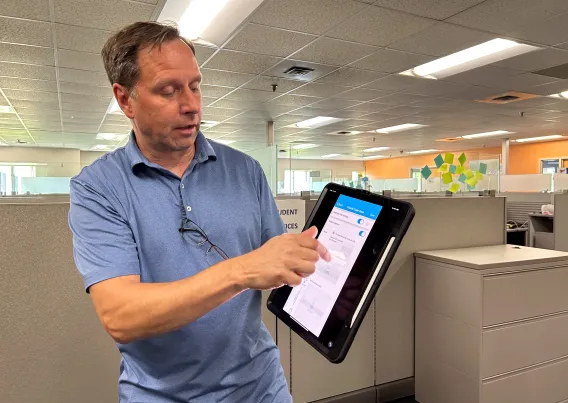 A person adjusting lights with an tablet. 