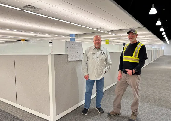 two people standing in office