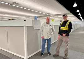 two people standing in office